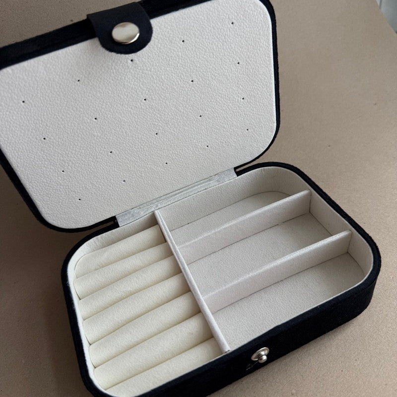 Sort smykkeskrin i velour med flere rum til opbevaring, set fra oven