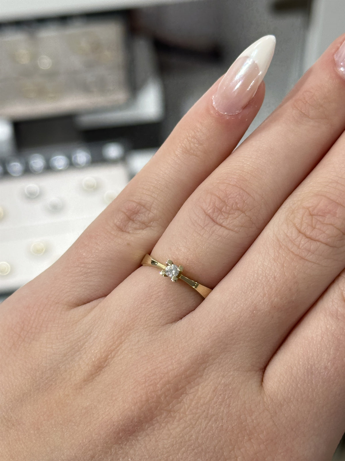 Nuran diamantring i 14 karat guld med 0,10 ct brillant i fire-grabber fatning, set fra siden